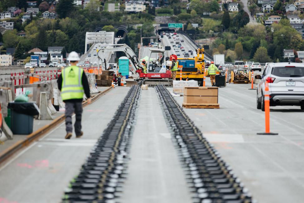 Workers prepare the I-90 floating bridge for rail installation last year. 