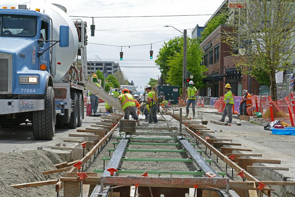 A cement truck is parked next to light rail tracks under construction in Tacoma's Hilltop neighborhood.