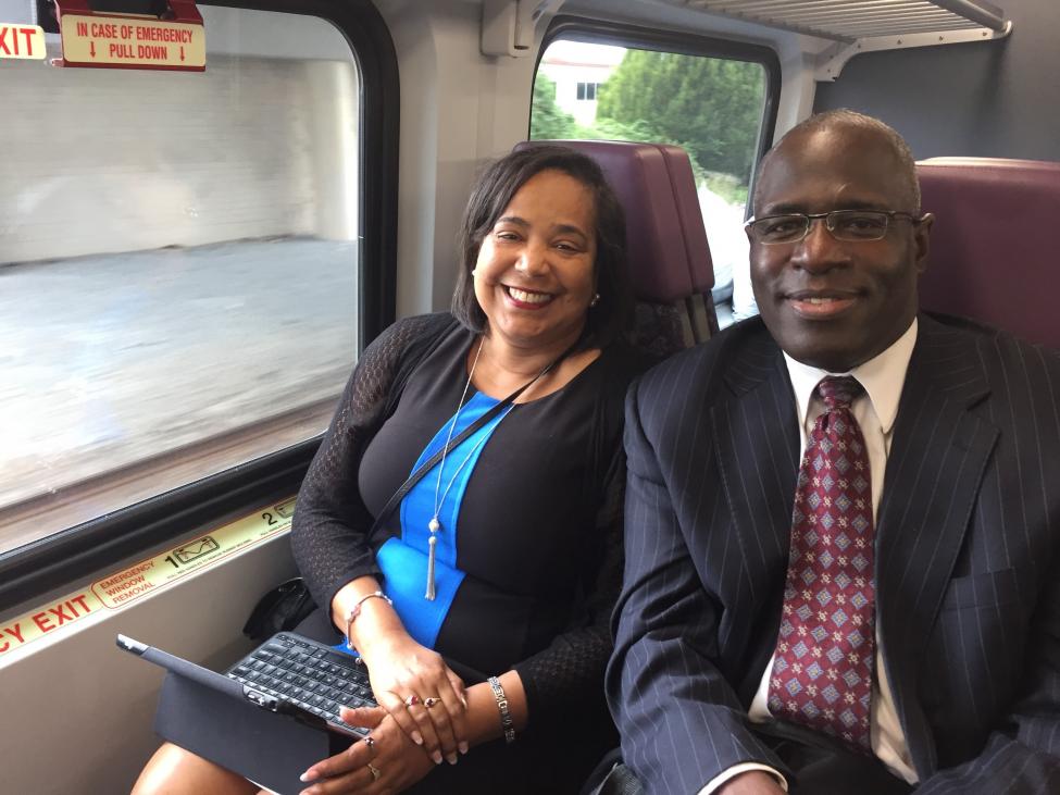 Sound Transit board members Victoria Woodards and Kent Keel sit next to each other on a Sounder train.