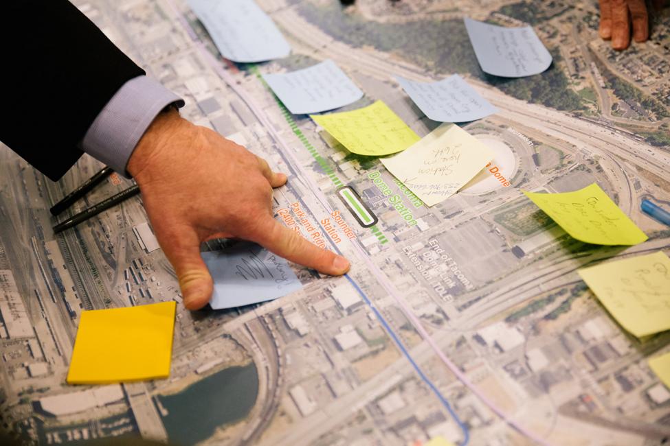 Photo of a hand pointing to a map, Tacoma Dome Link Extension Open House