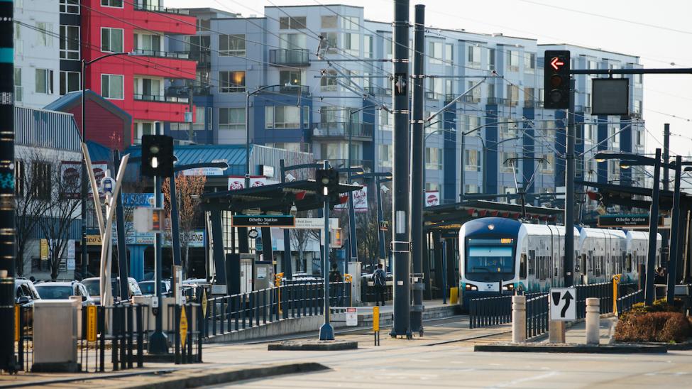 A Link train passing through Othello Station with transit oriented development in the background