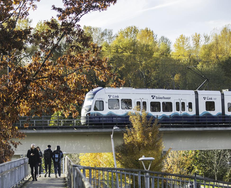 Photo of people walking on a pedestrian bridge next to Mount Baker Link Light Rail Station, West Seattle and Ballard Link Extensions