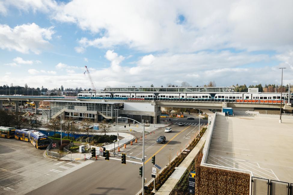 A light rail test train sits on the tracks at the Northgate Station platform. 