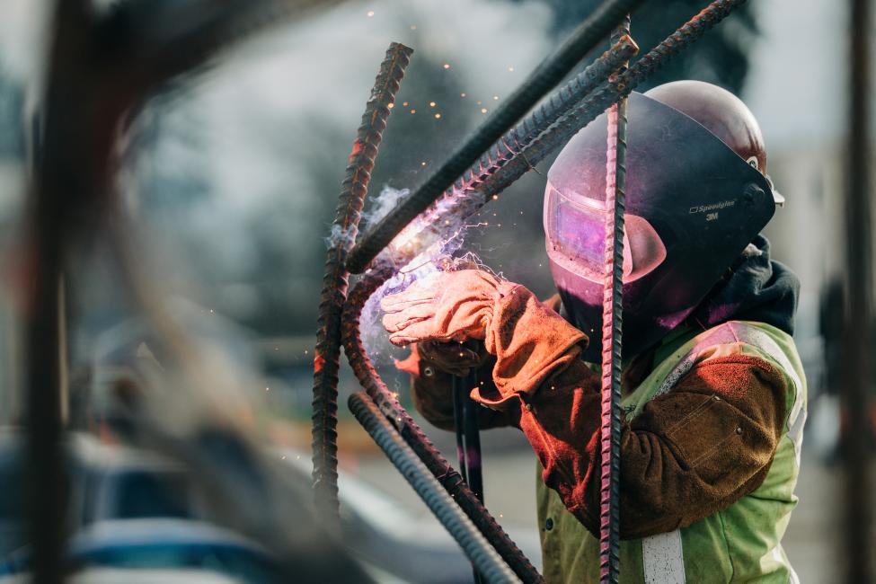 Sparks fly as an Ironworker in a protective mask welds rebar for the Link light rail extension to Federal Way. 