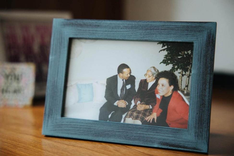 A framed photo of Leslie Jones, Jones' husband and Rosa Parks sitting on a couch.