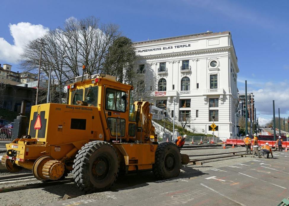 A large bulldozer is parked in front of the McMenamins in Tacoma.