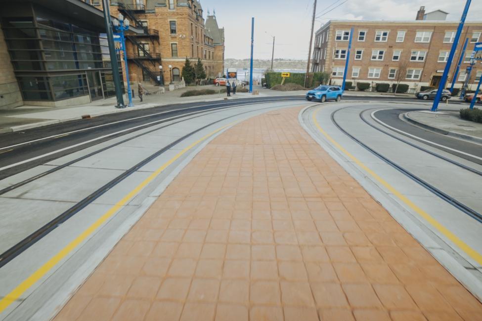 Two light rail tracks can be seen in the road on N 1st St in the Stadium District of Tacoma.