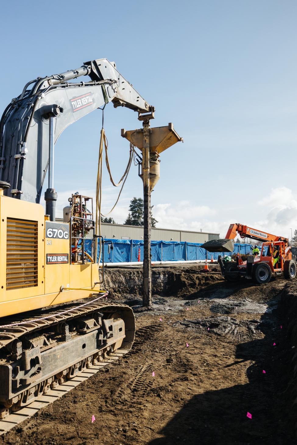 A heavy piece of construction equipment is used to Crews install stone column ground improvements.