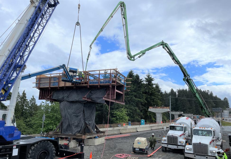 Concrete pumper trucks pouring the concrete into the final of 188 Lynnwood Link columns that will support the Link light rail guideway.  ​