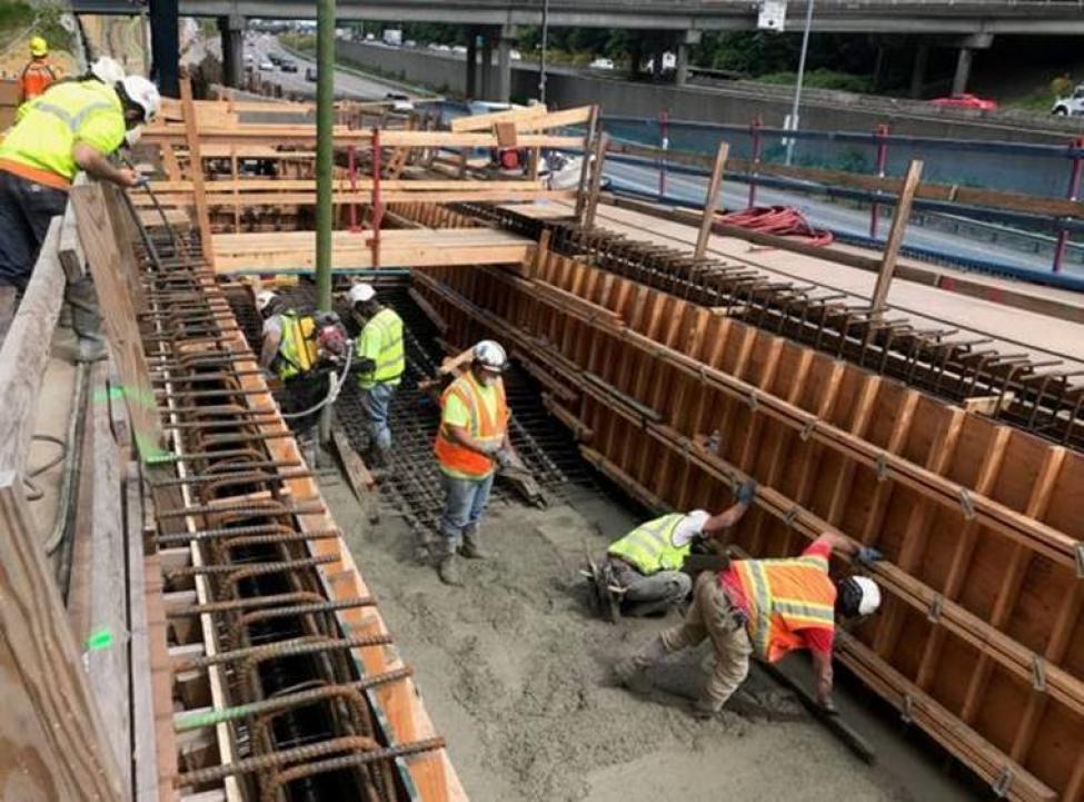 Union Masons smooth out the concrete as it's pumped into the new bridge over I-5.