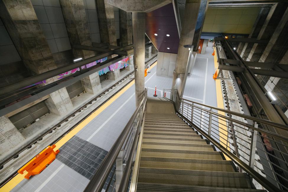 Looking down the finished stairs from the mezzanine landing to the platform at Roosevelt Station.