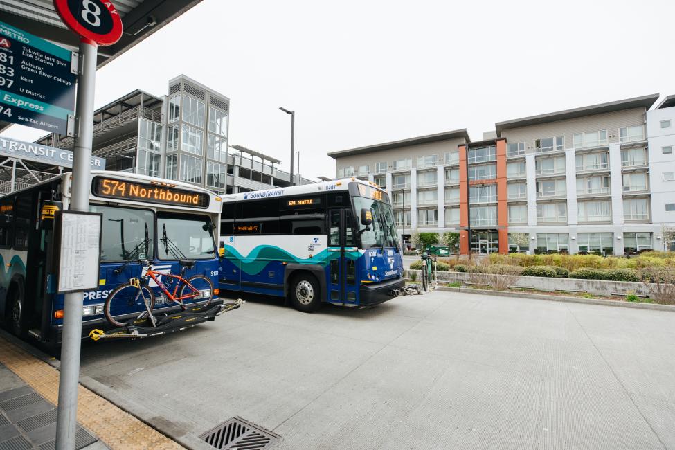 Two buses drive side by side.