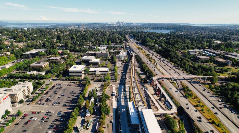 An aerial shot of Northgate Station on a clear day with downtown Seattle, Green Lake and Mount Rainier visible in the background.