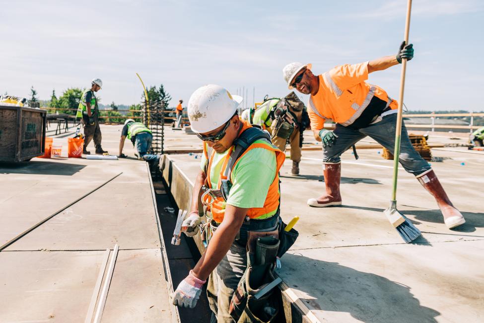 Carpenters install formwork for the concrete at the upper deck of the garage.