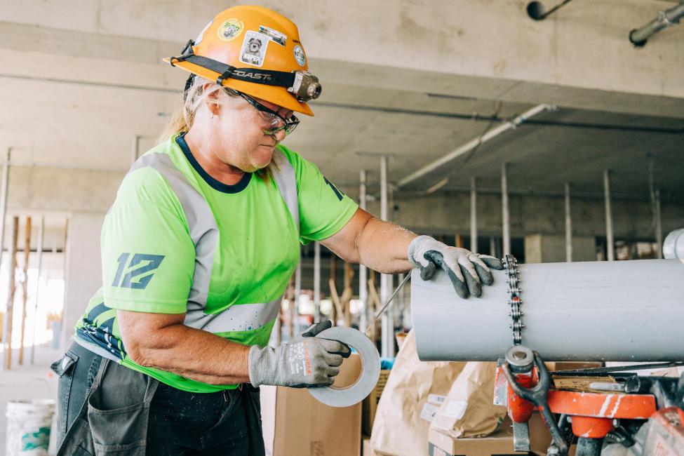 Seahawks fan/electrician prepares conduit sleeves for installation in the garage.