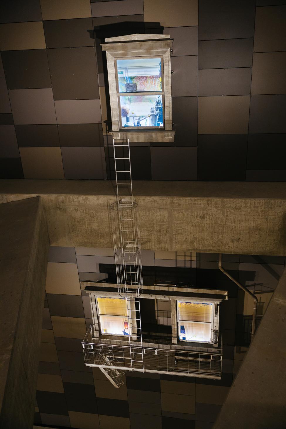 Art on the wall at U District Station looks like the windows of apartment buildings.