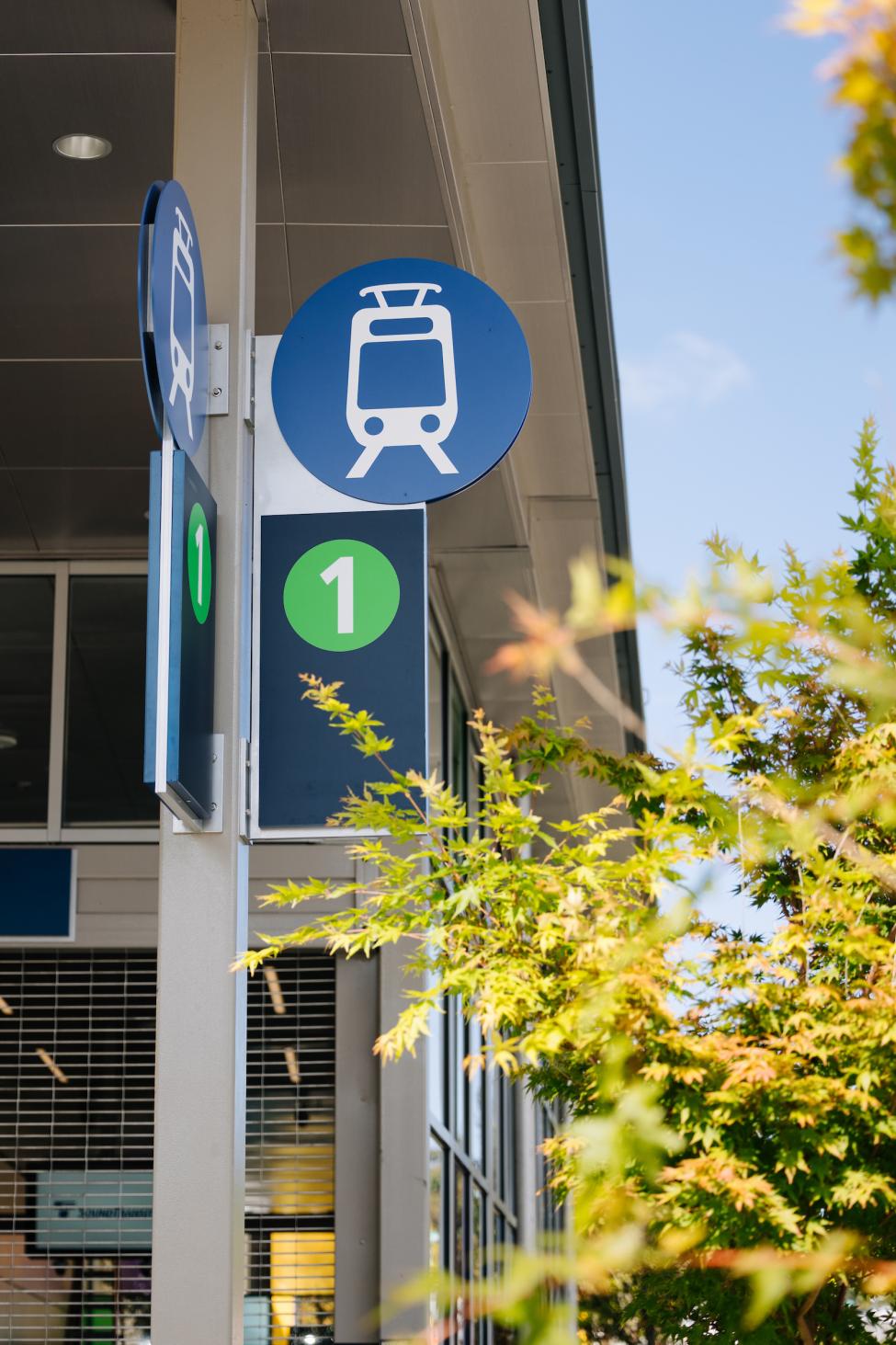 A sign shows the Link light rail icon and a green number "1."