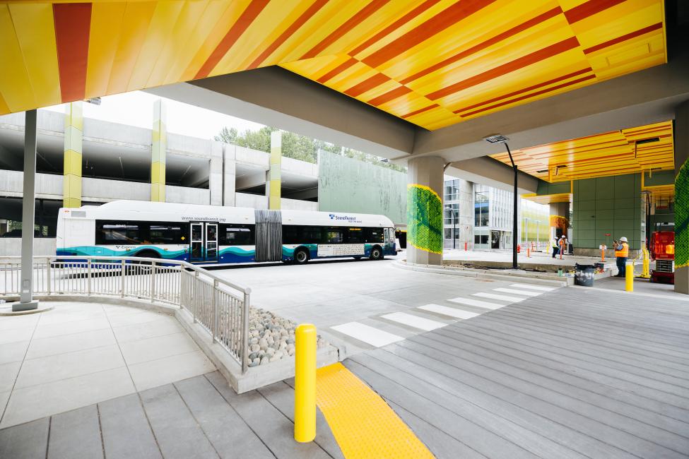 A Sound Transit Express bus drives by the new South Bellevue light rail station.