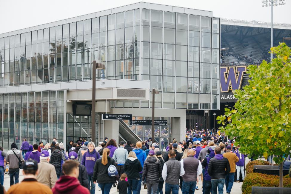 Crowds file in to watch Husky football from UW Station.