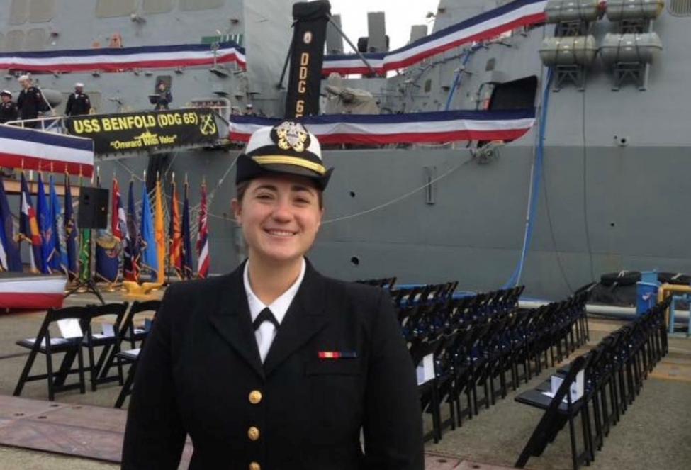 Presley Morrisey in her Navy uniform with a boat in the background.