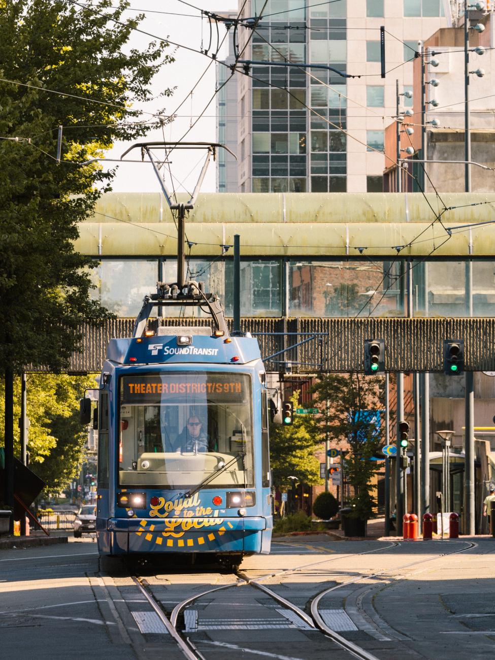 A Tacoma Link light rail trains makes it's way through downtown Tacoma on a bright summer day. 