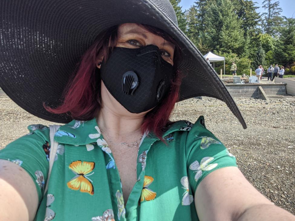 Emily Von Seele wears a floppy hat and face mask.