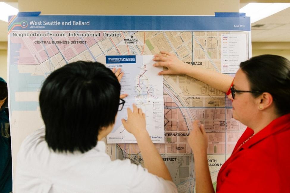 Community members explore maps of the potential station locations along the project corriddor.