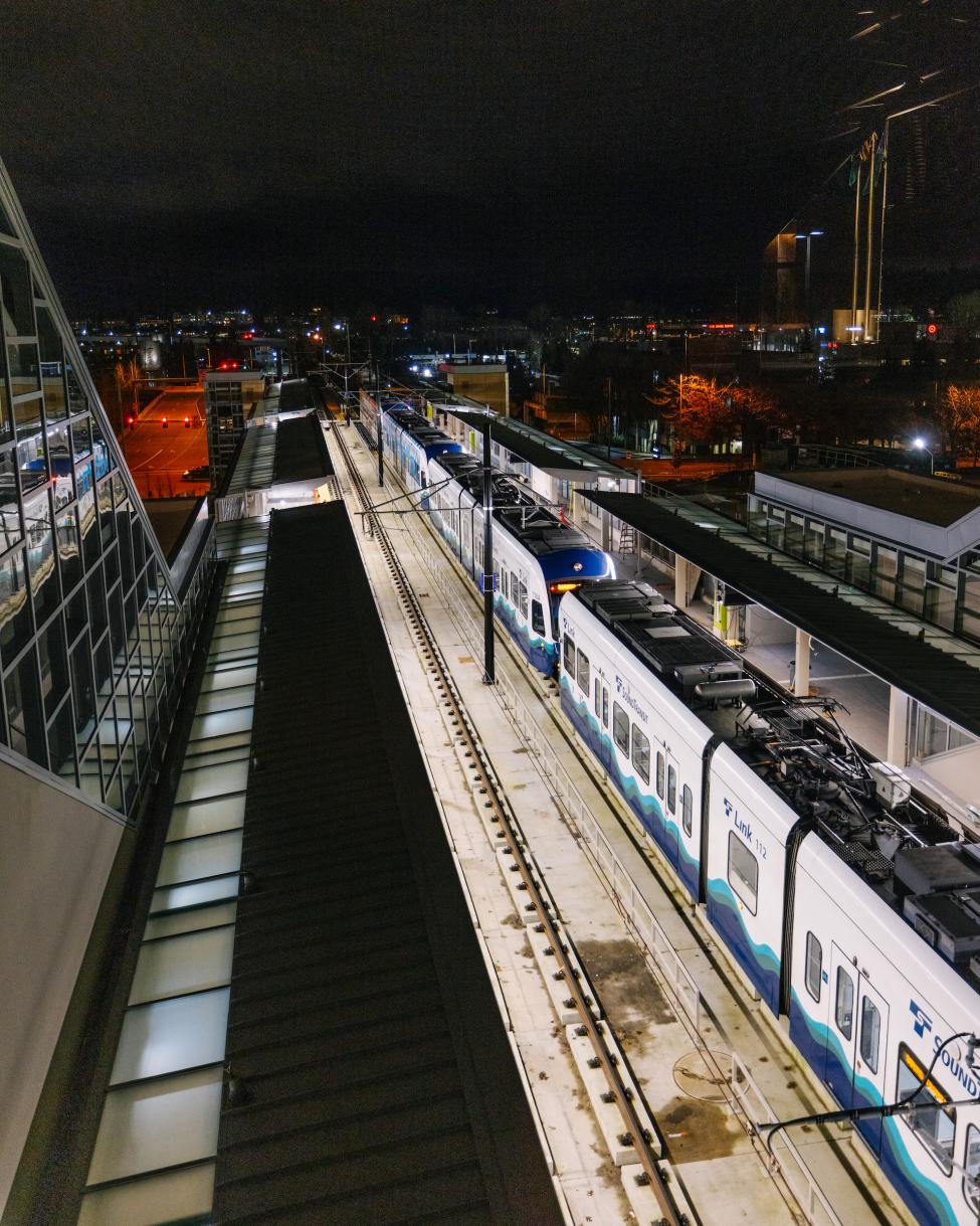 A Link train pulls into the Downtown Bellevue station at night.