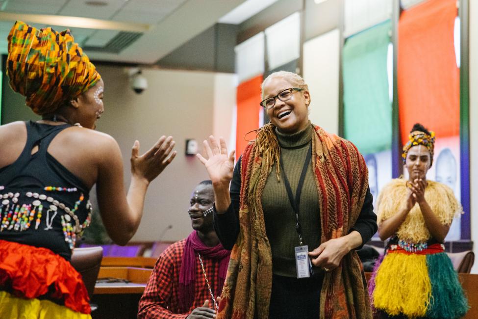 Galen high-fives a dancer at a Black History Month celebration.