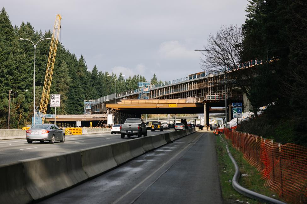 Cars travel underneath the future light rail bridge.