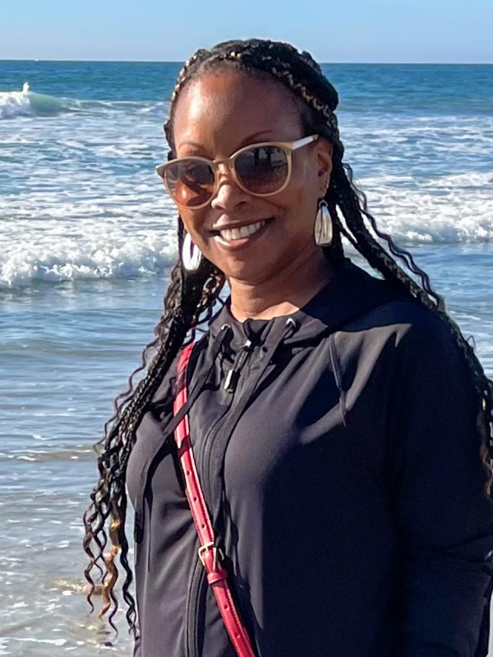 LaTonya Kadar wears sunglasses at the beach on a sunny day.