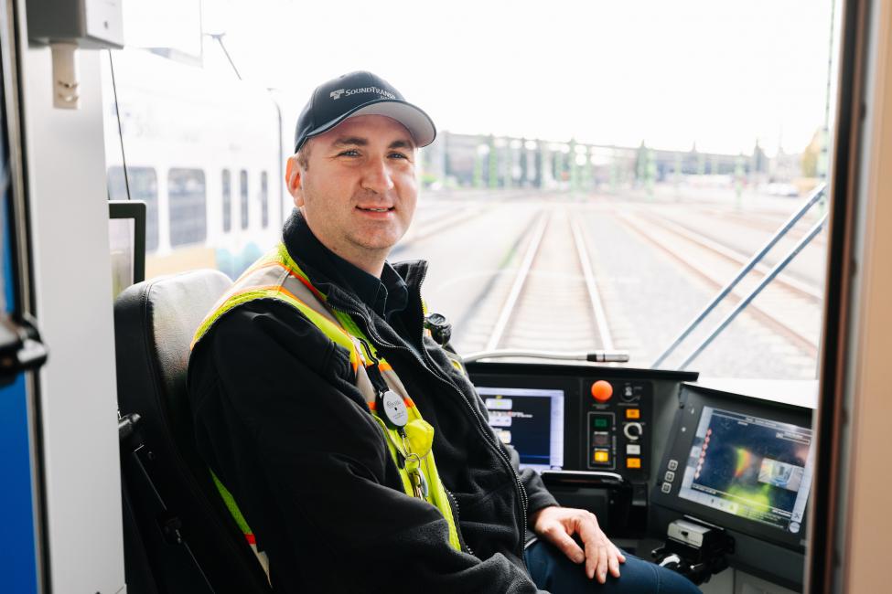 Allen Card sits in the operator cab of a Link train.