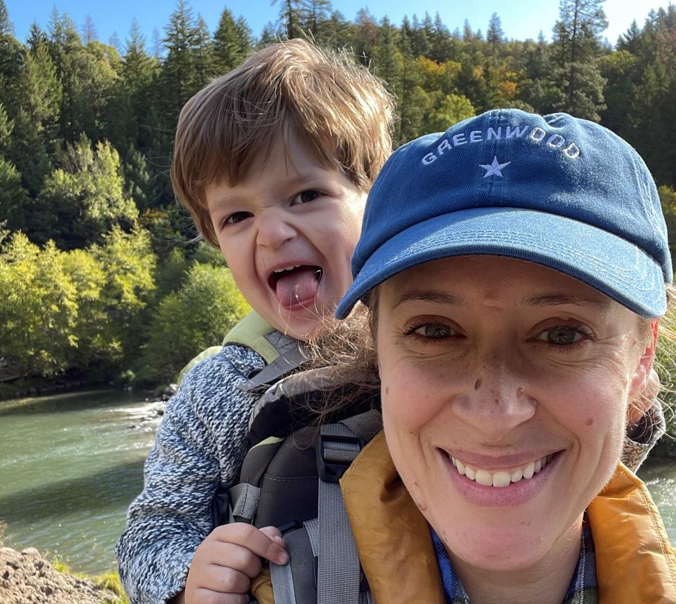 Jamie Brinkley carries a child in a backpack while hiking.