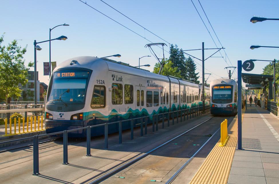 Two trains passing north and south at Columbia City Station in Seattle.