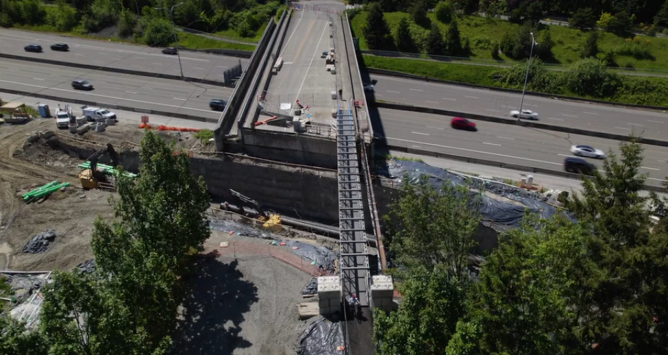 A drone shot of a pedestrian bridge over the NE 60th Street overpass. 
