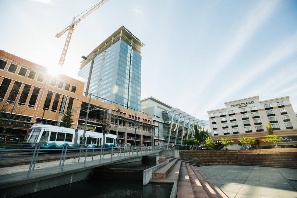 Tacoma Link moves through downtown, with a crane in the background.