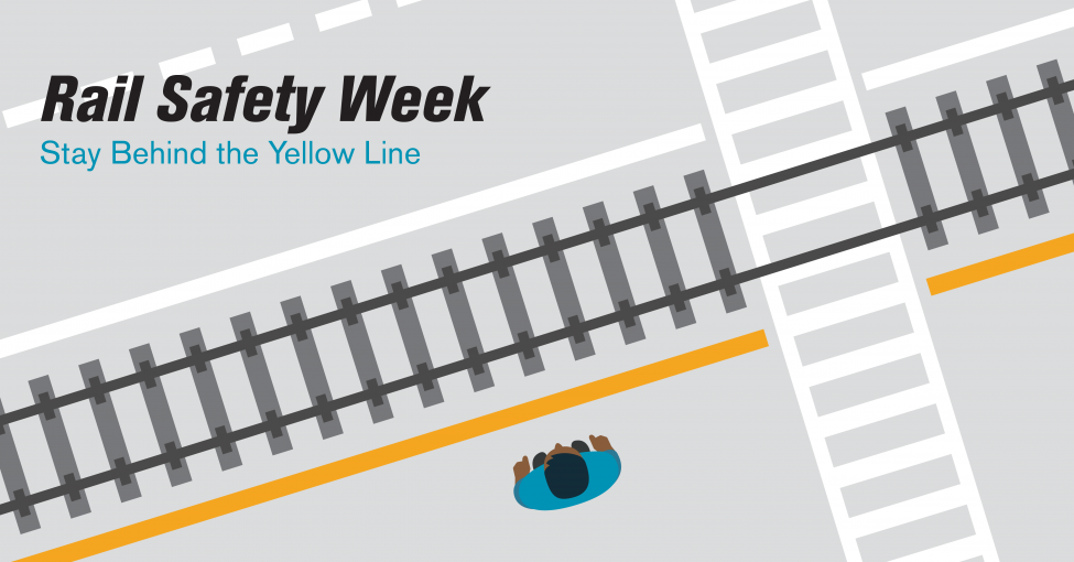 A graphic of a person standing behind the yellow line near train tracks.
