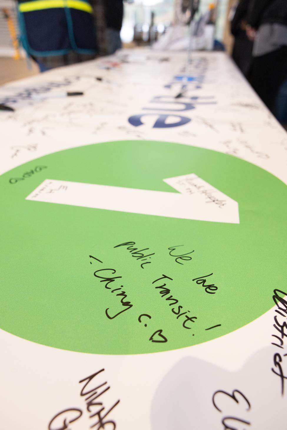 Script written on a banner reads " We love public transit."