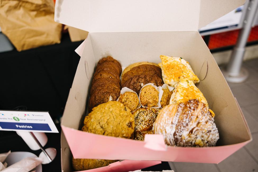 A box of pastries in a pink box.