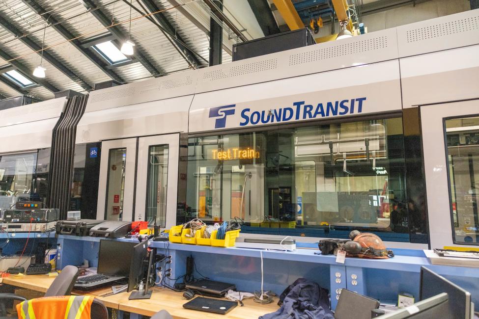 A view of the side of the Tacoma Link vehicle, with the signature Sound Transit blue and green wave painted on.