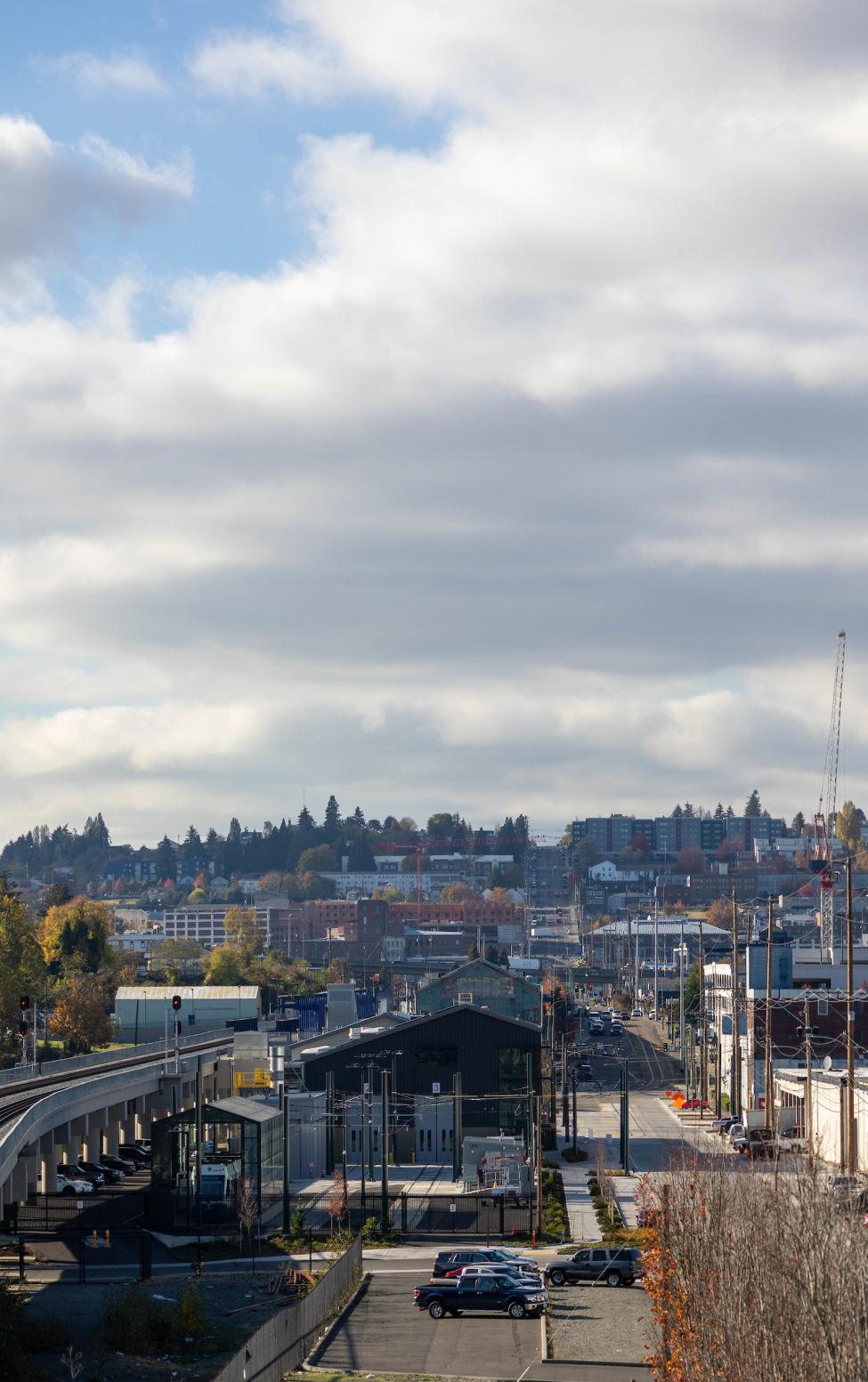 A shot of Tacoma, with trees with changing leaves and a cloudy sky.