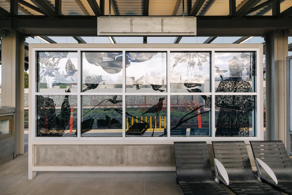 Etched drawings by Barbara Earl Thomas are installed on the glass platform windscreens.