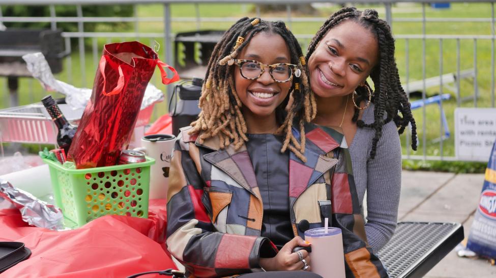 Simbi hugs a fellow employee at a picnic