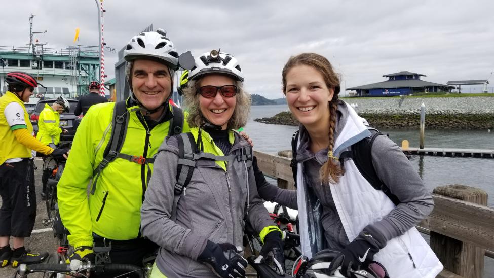 Denis Martynowych, wife Diane and daughter Anika ride their bikes to a ferry.