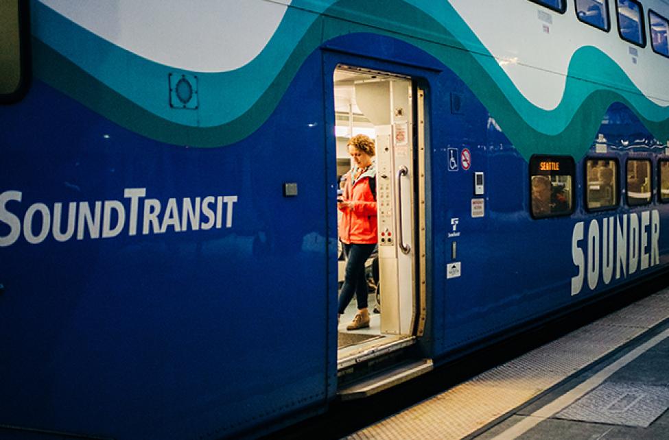 A passenger standing inside a Sounder train.