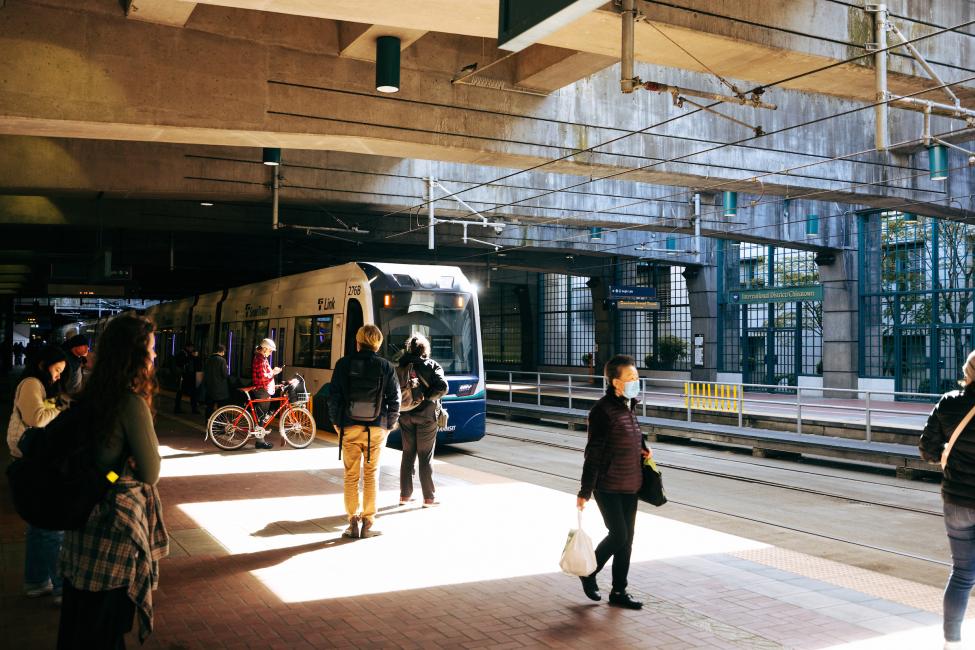 People wait on the platform at IDS as a Link train pulls in 