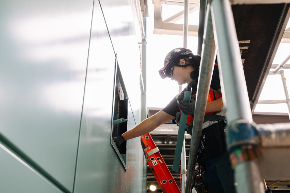 A worker uses a power tool 