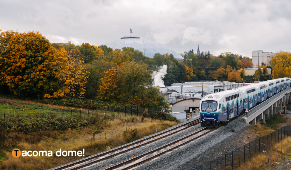 A Sounder train on the tracks in front of the Tacoma Dome