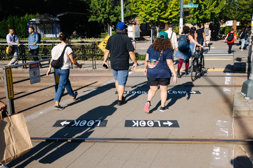 A group of pedestrians safely crosses the street in the Rainier Valley