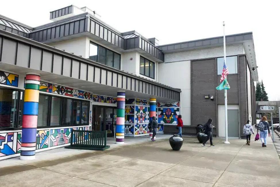 The front of a school, with mural artwork